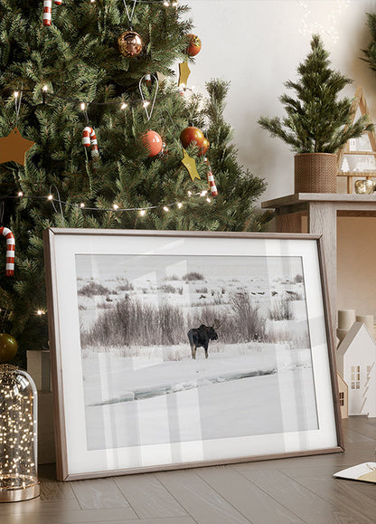 a christmas tree with a picture of a moose in front of it